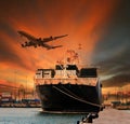 Container ship and container in shipping port cargo plane flying above Royalty Free Stock Photo