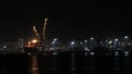 Container ship discharging at the port at night, port of novorossiysk, unmoored ship go out of the port