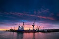 Container ship docked at industrial port. Sunset silhouettes cranes, vessel ready for global trade. Maritime cargo Royalty Free Stock Photo