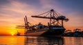 Container Ship Docked at a Port with Cranes at Sunset cargo ship harbor Royalty Free Stock Photo