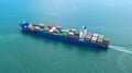 Container ship in export and import business and logistics. Shipping cargo to harbor by crane. Water transport International. Royalty Free Stock Photo
