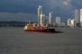 A Container Ship that has been emptied being pushed out to sea