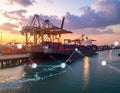 Container ship loaded at port with cranes sunset sky Data icons overlayed Royalty Free Stock Photo