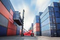 Container Ship Loading of Import/Export Freight Transportation Industry, Transport Crane Forklift is Lifting Box Containers at Royalty Free Stock Photo