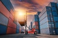 Container Ship Loading of Import/Export Freight Transportation Industry, Transport Crane Forklift is Lifting Box Containers at Royalty Free Stock Photo