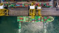 Container ship loading and unloading in deep sea port, Aerial top view of logistic import export transportation business by