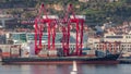 Container ship loading and unloading in sea port timelapse. Aerial view cargo freight ship with red cranes in port of Royalty Free Stock Photo