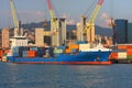 A container ship moored in the calm channel of the port of Genoa Royalty Free Stock Photo