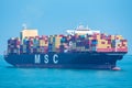 Container ship `MSC Josseline` sailing through calm blue ocean. Royalty Free Stock Photo