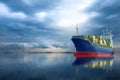 Container ship in ocean on storm sky . Royalty Free Stock Photo