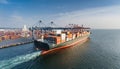 Container ship in port terminal - huge freighter fully loaded