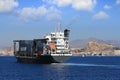 Container ship sailing close to the city of Alicante. Royalty Free Stock Photo