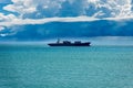 Container Ship in the Sea under Cumulonimbus Clouds with Rain Royalty Free Stock Photo