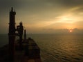 Container ship at the sunset, sun near the horizont