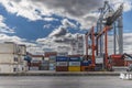 A container ship unloading at the dock in the port of the city of Lisbon Royalty Free Stock Photo