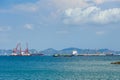 Container ships anchor along a deep seaport in daylight