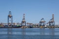 Container ships moored at a container terminal in the Port of Rotterdam. The port is the Europ`s largest and facilitate the needs