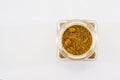 A container with spices on a white background. Spices for pilaf in a glass jar. Top view Royalty Free Stock Photo
