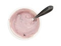Container of stirred black cherry Greek yogurt with spoon