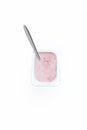 Container with strawberry yogurt and spoon, top view, isolated o Royalty Free Stock Photo