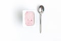 Container with strawberry yogurt and spoon, top view, isolated o Royalty Free Stock Photo