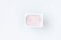 Container with strawberry yogurt, top view, on white ba Royalty Free Stock Photo