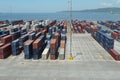 Container terminal with boxes from different shippers lined in the Port of Kingston.