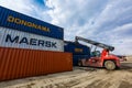Summer, 2016 - Primorsky Krai, Russia - Container terminal. Large forklift lifts a metal container
