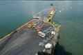 Container terminal in Puerto Barrios with old empty trucks and lorries parked on a loading pier.