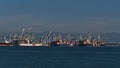 Container terminal of Roberts Bank Superport in the Strait of Georgia part of Vancouver Harbour, with three loading cargo vessels.