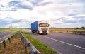 A container truck with a semi-trailer transports cargo from a port to another country along the highway in the summer Royalty Free Stock Photo