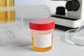 Container with urine sample for analysis on white table in laboratory Royalty Free Stock Photo