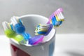 Container with used colorful toothbrushes