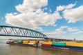 Container vessel passing a bridge on the Dutch river Waal in Nijmegen Royalty Free Stock Photo