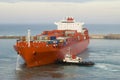 Container vessel and a small tug boat Royalty Free Stock Photo