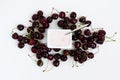 Container with yogurt and a bunch of fresh cherry berries on white background, isolated, top view Royalty Free Stock Photo