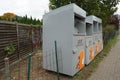 Containers for collecting old clothes and shoes are located on the street. Berlin, Germany Royalty Free Stock Photo