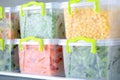 Containers with frozen vegetables in refrigerator Royalty Free Stock Photo