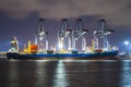 Containers loading by big crane at dark sunset, Shipping Trade Port Royalty Free Stock Photo