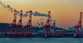 Containers loading by crane with sunrise.