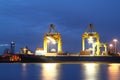 Containers loading at sea trading port at twilight