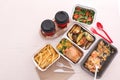 Containers with tasty takeout meals on light background, top view. Food delivery