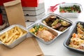 Containers with tasty takeout meals on table. Food delivery