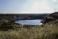 Contaminated pond lake of an old abandoned mining landscape for copper mining with red earth