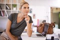 Contemplating the next big project. A confident young businesswoman sitting at her desk looking thoughtful. Royalty Free Stock Photo