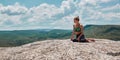 Contemplation and Sport idea. Woman sitting on mountain, Enjoying virgin nature landscape. Green hills. Copy space Royalty Free Stock Photo