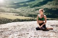 Contemplation. Yoga time. Sport. Woman sitting on mountain. Enjoying virgin nature landscape. Green hills. Copy space