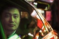 Contemplative Businessman in the back seat of a car looking out through window at night, Beijing Royalty Free Stock Photo