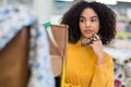 contemplative craftswoman holding eyeglasses