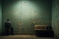 Contemplative man sitting alone in front of the door. Home room Royalty Free Stock Photo